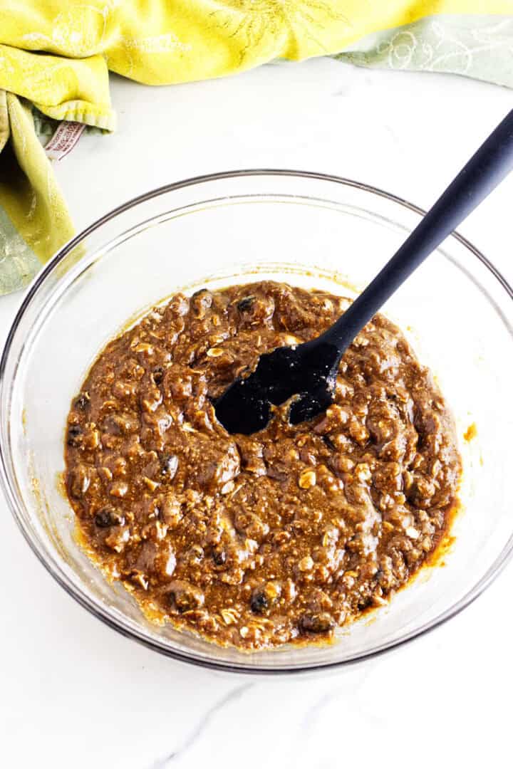 Thick brown Sailor Jack batter with visible raisins and oats in a glass mixing bowl.