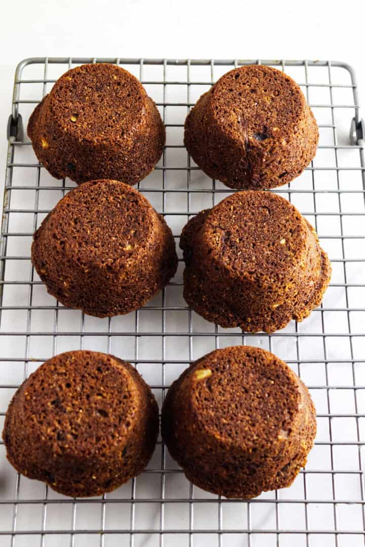Baked Sailor Jack muffins cooling upside down on a wire rack.